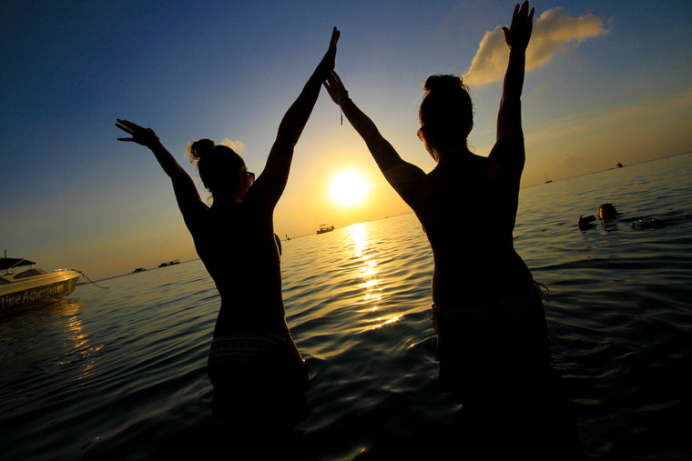 Friends at lake during sunset